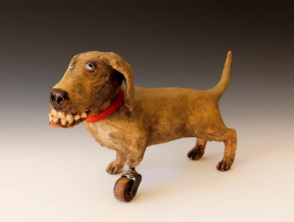 Dog with Antique Wheel — ceramic and mixed-media sculpture by Steve Jones